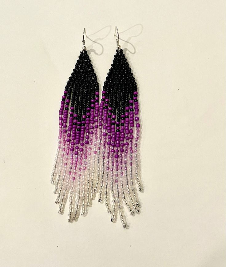 Beautiful pair of earrings made with 10/0 black , dark purple, purple, light purple and silver beads. I have used good quality nylon thread and ear wires . Please message me if you have any questions. I have two of these earrings in stock . If you want more of these I can make it in 2 -3 days and ship them. Thanks for visiting. Purple Long Drop Beaded Earrings With Dangling Beads, Purple Beaded Earrings With Tassels For Gift, Purple Beaded Earrings With Tassels, Purple Beaded Dangle Earrings With Black Beads, Purple Dangle Beaded Earrings With Black Beads, Purple Beaded Fringe Earrings As Gift, Purple Fringe Beaded Earrings As Gift, Purple Fringe Tassel Earrings Gift, Purple Tassel Drop Earrings With Dangling Beads