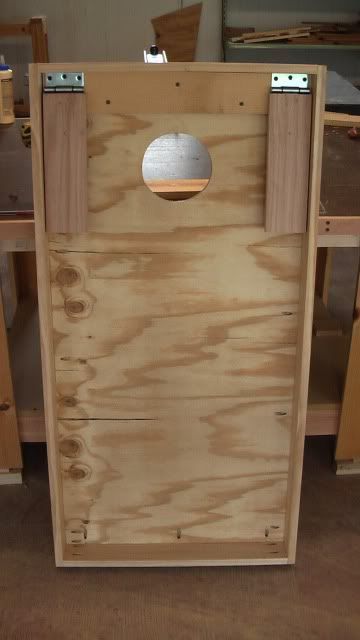 a wooden box with a round hole in it