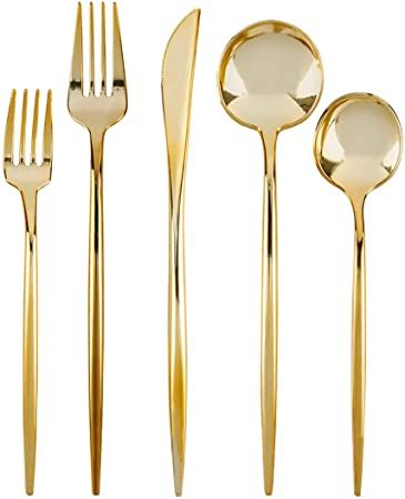 gold colored utensils and spoons on a white background