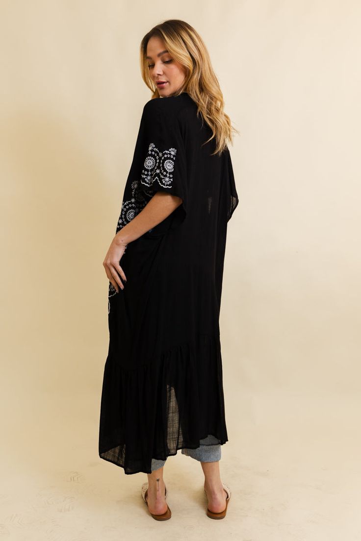 Introducing our Boho Tribal Embroidered Longline Kimono – a statement piece that effortlessly blends style and cultural flair! This longline kimono features intricate tribal embroidery, adding a bohemian touch to your wardrobe. With a relaxed fit and flowing silhouette, it's perfect for layering over any outfit. Whether you're hitting the festival scene or looking for a boho-chic layer for everyday wear, this kimono has you covered. Elevate your style with the Boho Tribal Embroidered Longline Kimono – where fashion meets cultural inspiration in one stunning piece! #lovemyleto 100% Viscose Imported Black Bohemian Maxi Length Kimono, Black Bohemian Tunic Kimono, Bohemian Kimono With Intricate Embroidery, Long Floral Embroidered Kimono For Festival, Long Floral Embroidery Kimono For Festivals, Bohemian Chikankari Embroidered Kimono For Spring, Bohemian Kimono With Chikankari Embroidery For Spring, Bohemian Chikankari Kimono For Spring, Bohemian Long Kimono With Intricate Embroidery