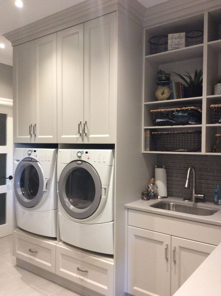 a washer and dryer in a white laundry room