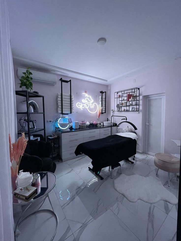 a living room filled with furniture and a neon sign on the wall above it's desk