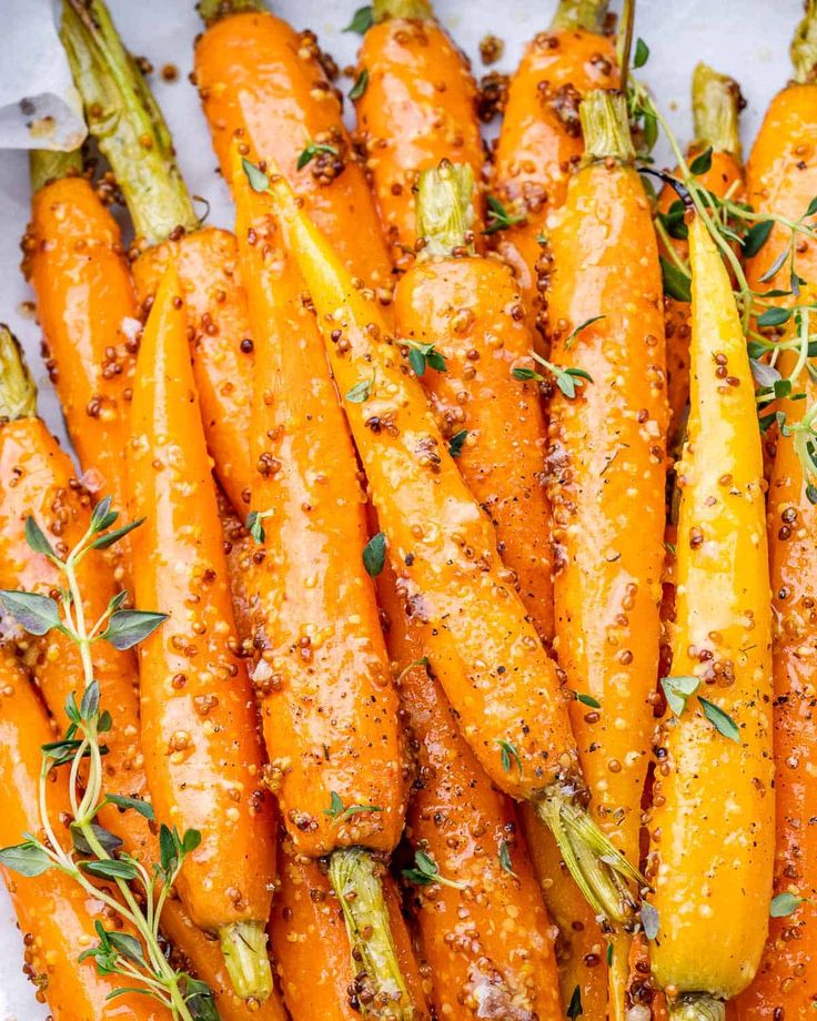 roasted carrots with herbs and seasoning on top