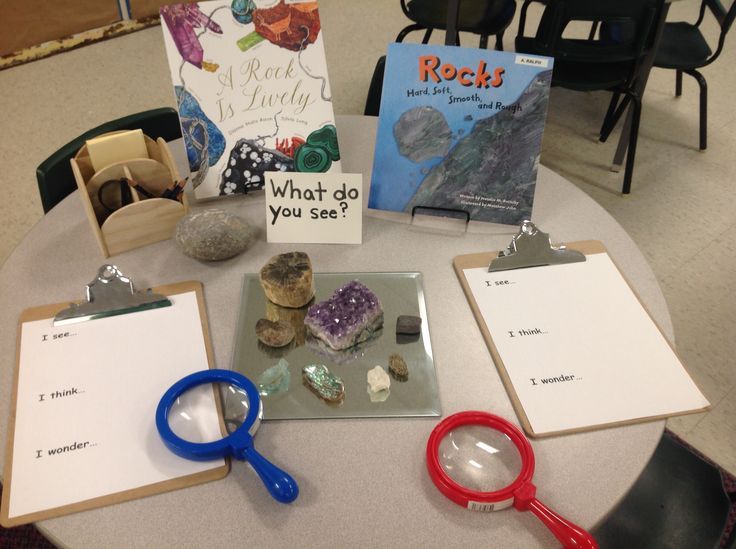 a table topped with lots of different types of rocks and paper on top of it