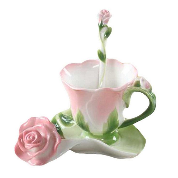 a pink rose sitting in a cup on top of a saucer