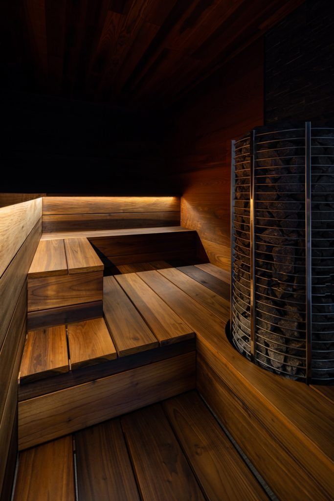 the inside of a sauna with wooden floors and lighting on it's sides