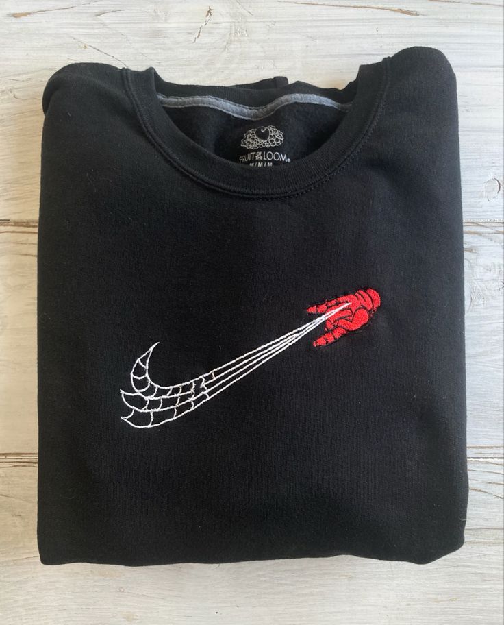 a black t - shirt with red and white design on it