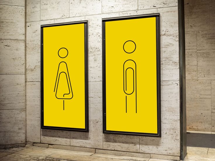 there are two yellow signs on the wall next to each other in this public restroom