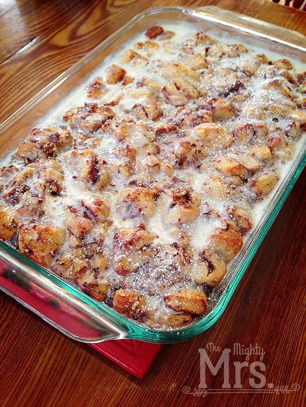 a casserole dish is sitting on a wooden table and ready to be eaten