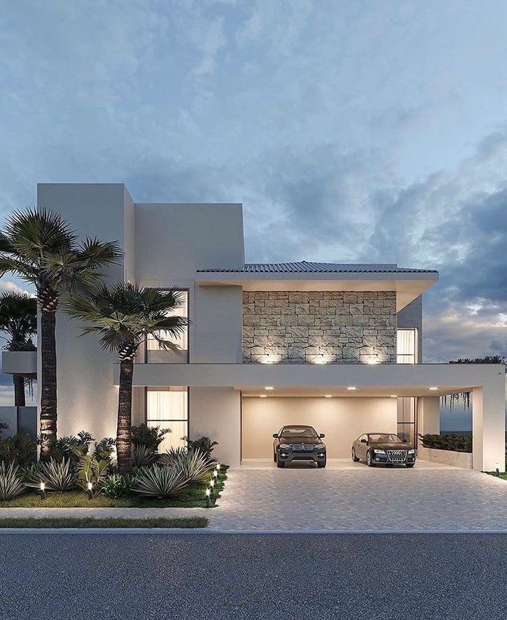 two cars are parked in front of a modern house at dusk with palm trees on the side