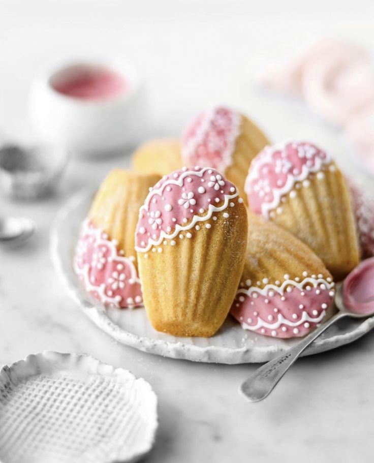 some pink and white cupcakes on a plate