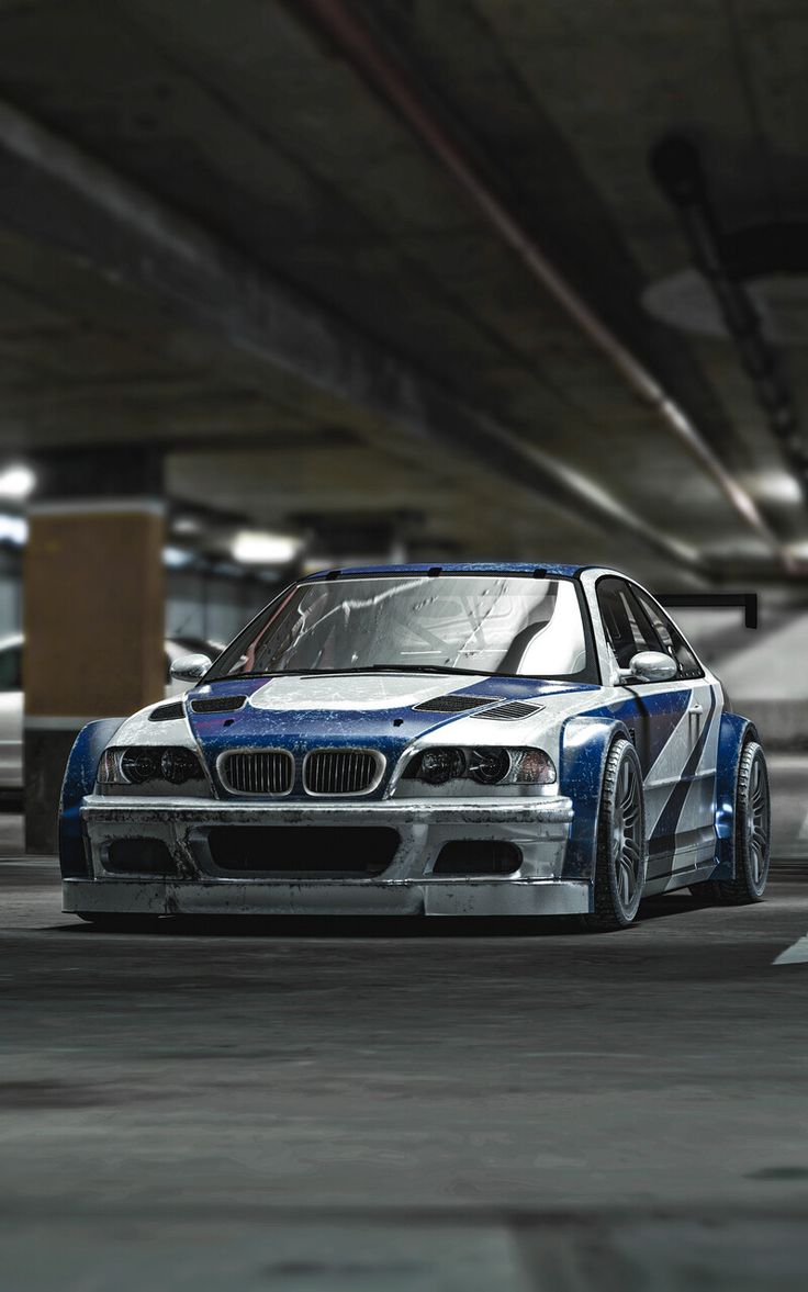 a blue and white car parked in a parking garage