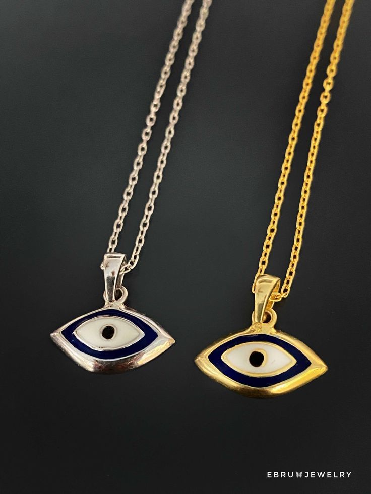 The Dainty Evil Eye Necklace is perfect for you if you're looking for something simple to wear every day. This beautiful necklace features a small evil eye charm on a sterling silver chain and will brighten your day with its protective energy and bring you good luck. This necklace comes in a silver and a 18k gold plated variant. The Dainty Evil Eye Necklace also has a matching bracelet and earrings. The Evil Eye bead is a prominent symbol in Turkish and many other cultures, and is highly protect White Sterling Silver Amulet Necklace, Amulet Eye Necklace Gift, Symbolic Sterling Silver Necklace With Adjustable Chain, Good Luck Sterling Silver Necklace With Delicate Chain, Eye-shaped Amulet Necklace As Gift, White Sterling Silver Symbolic Necklace, Evil Eye Amulet Pendant Charm Necklace, Amulet Style Evil Eye Pendant Charm Necklace, Symbolic Necklaces With Silver Chain And Round Pendant