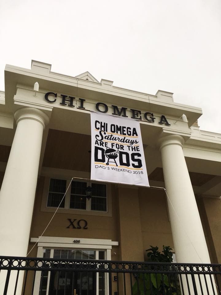 a sign hanging from the side of a building that says chiomega on it