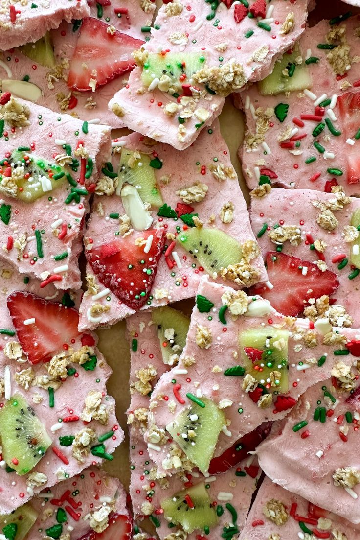 sliced strawberries, kiwis and sprinkles are arranged on top of each other