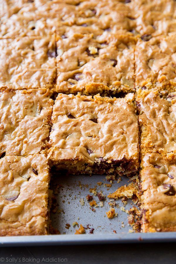 a close up of a tray of food with squares cut in half and on top