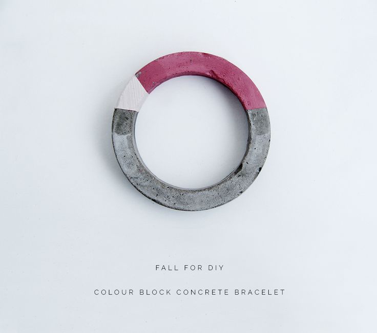 a circular object that is made out of concrete and has pink paint on the inside