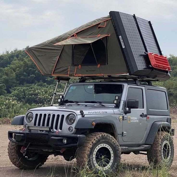 a jeep with a tent on the roof