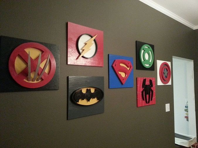 the wall is decorated with various superhero logos