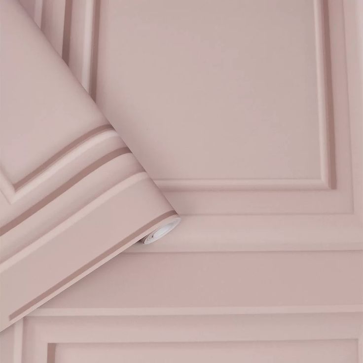 the corner of a pink wall with white trim