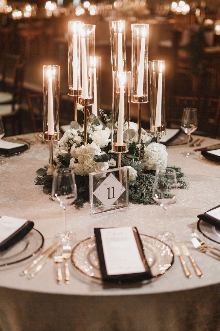 an elegant table setting with candles and flowers