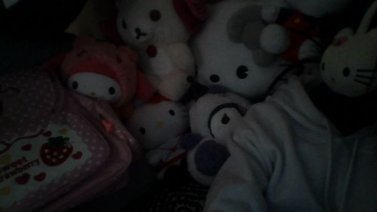 a pile of hello kitty stuffed animals sitting next to each other on top of a bed