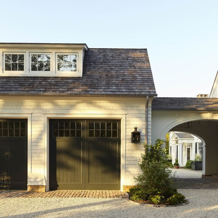 a house with two garages and an arched doorway