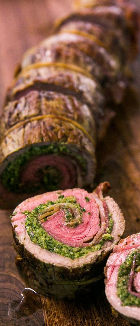 there is a roll with meat and pesto on it