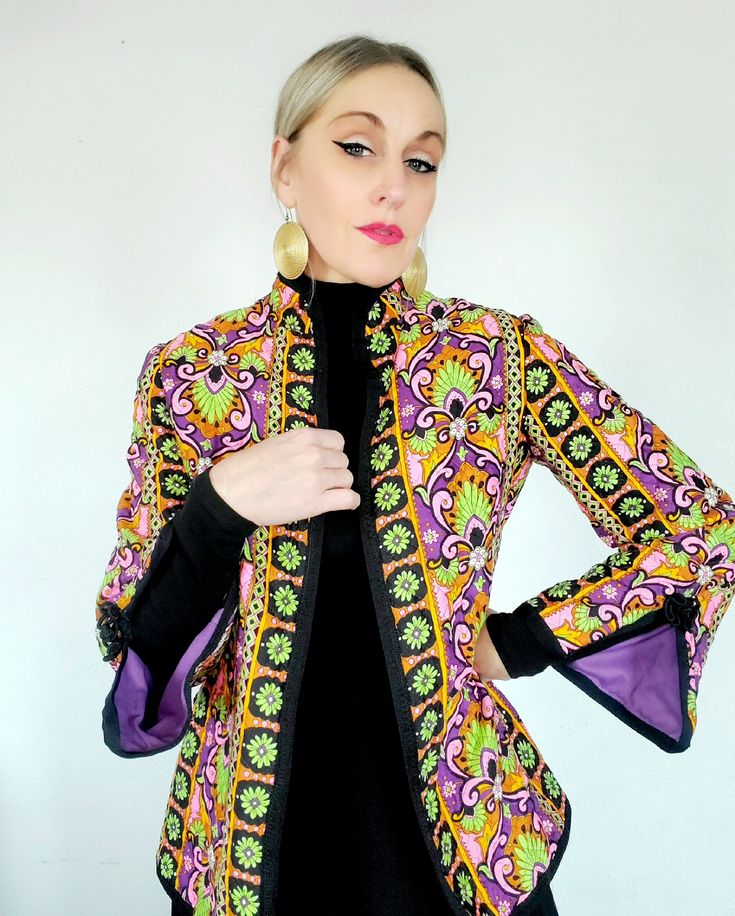 I LOVE this jacket!!  Groovy pattern, quilted but not too heavy, very comfortable.  Has the best sleeve details a purple lining . I think it is cotton blend, not sure.  It is in excellent condition and will fit a XS or a small. Fitted Multicolor Outerwear With Stand Collar, Retro Quilted Long Sleeve Outerwear, Quilted Retro Outerwear, Retro Purple Outerwear For Spring, Vintage Cotton Quilted Jacket For Fall, Vintage Quilted Multicolor Outerwear, Retro Cotton Blazer, Retro Cotton Blazer For Winter, Retro Long Sleeve Cotton Blazer