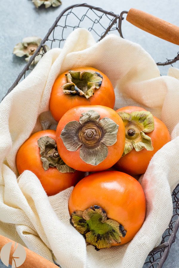 a basket filled with lots of ripe tomatoes