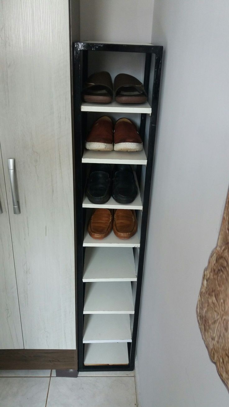 a shoe rack with several pairs of shoes in it