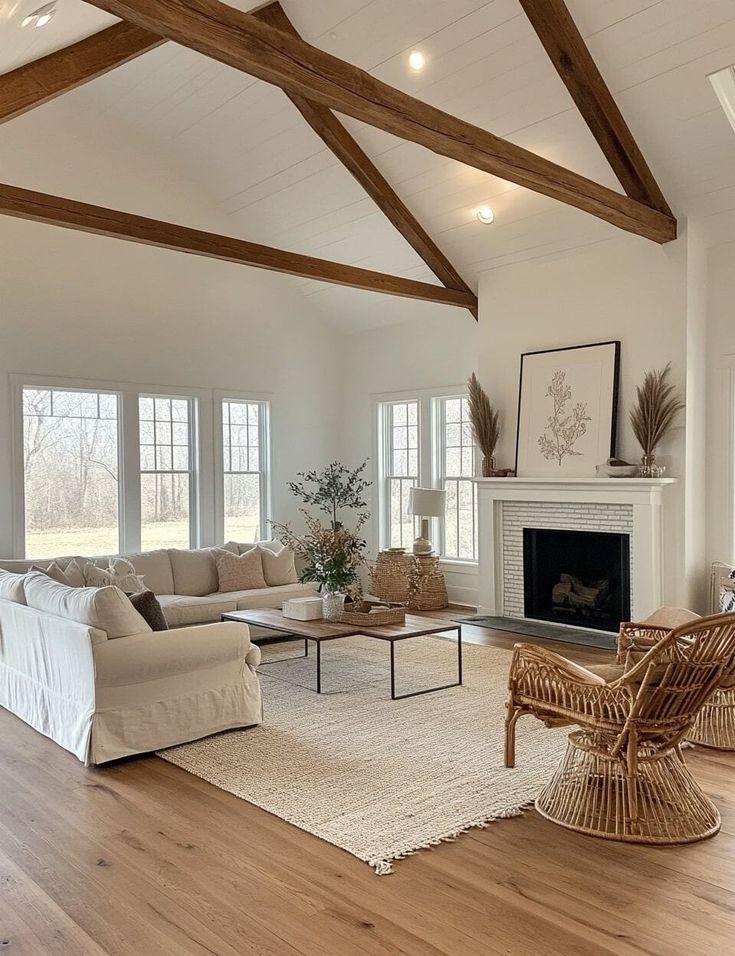 a living room filled with furniture and a fire place in the middle of an open floor plan