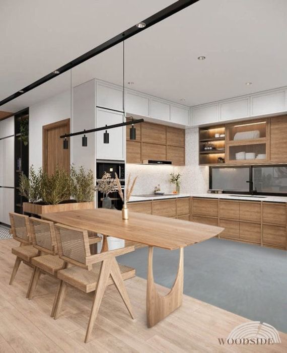 a modern kitchen with wooden cabinets and white walls, an island table surrounded by chairs