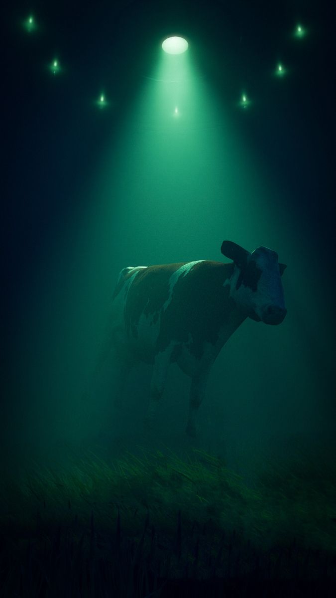 a cow standing in the middle of a field at night with lights shining on it