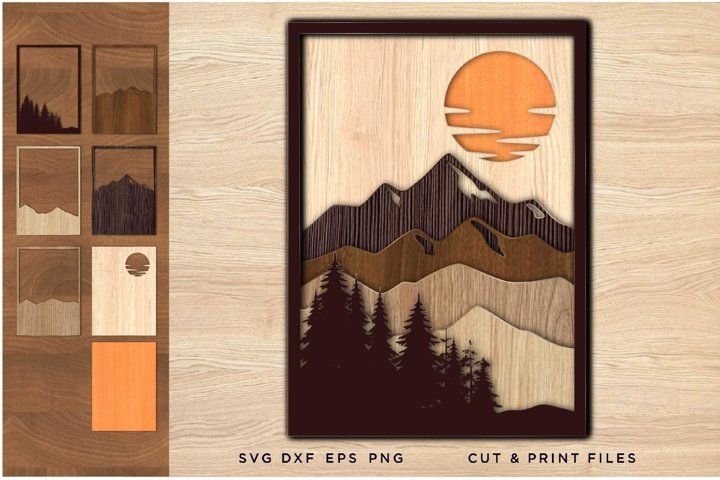 a wooden frame with mountains and trees on it