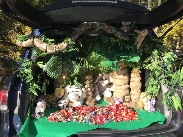 the trunk of a car filled with stuffed animals and plants