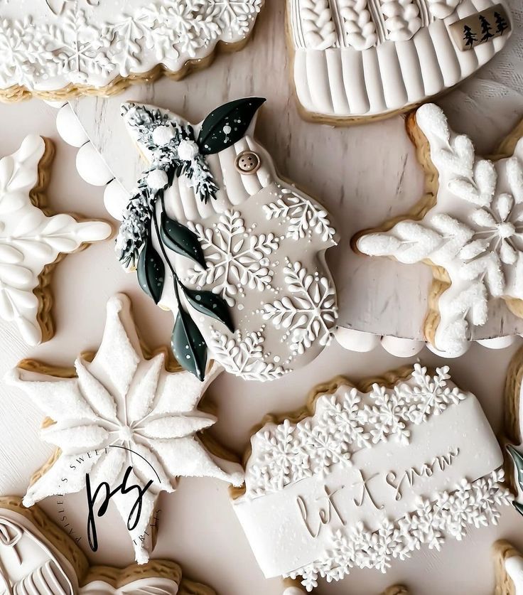 several decorated cookies on a white table