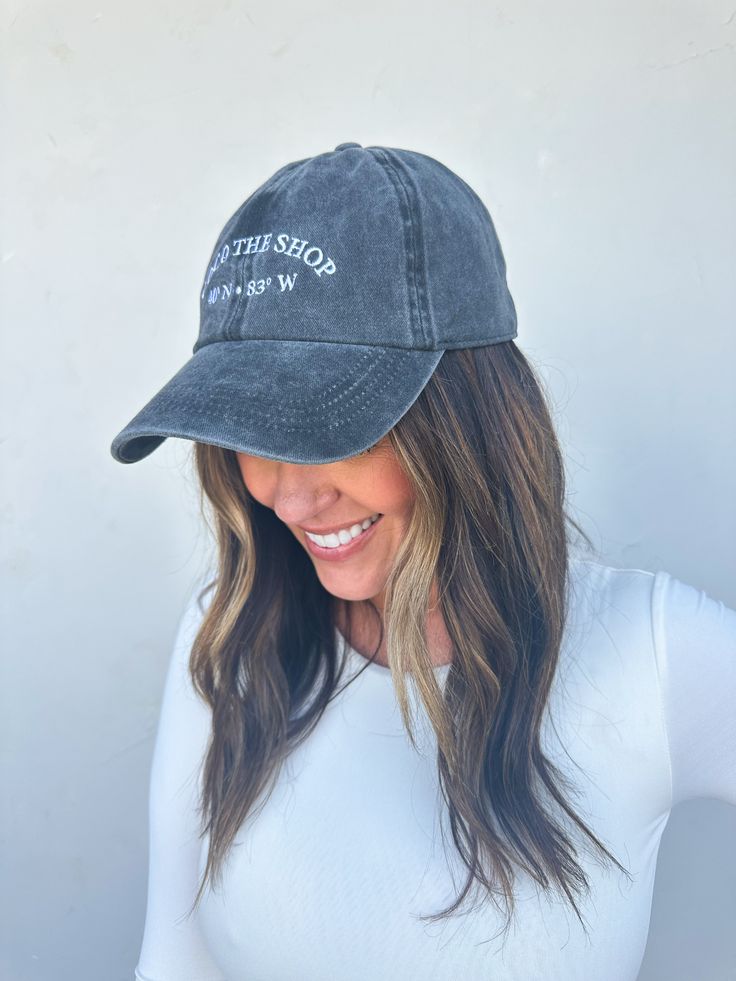 Washed charcoal baseball hat White embroidery of COCO THE SHOP and Columbus, OH coordinates Adjustable in back 100% cotton One size fits most Embroidered Hats, White Embroidery, Baseball Hat, Columbus, Dress Shop, Coco, Baseball Hats, Baseball, Embroidery