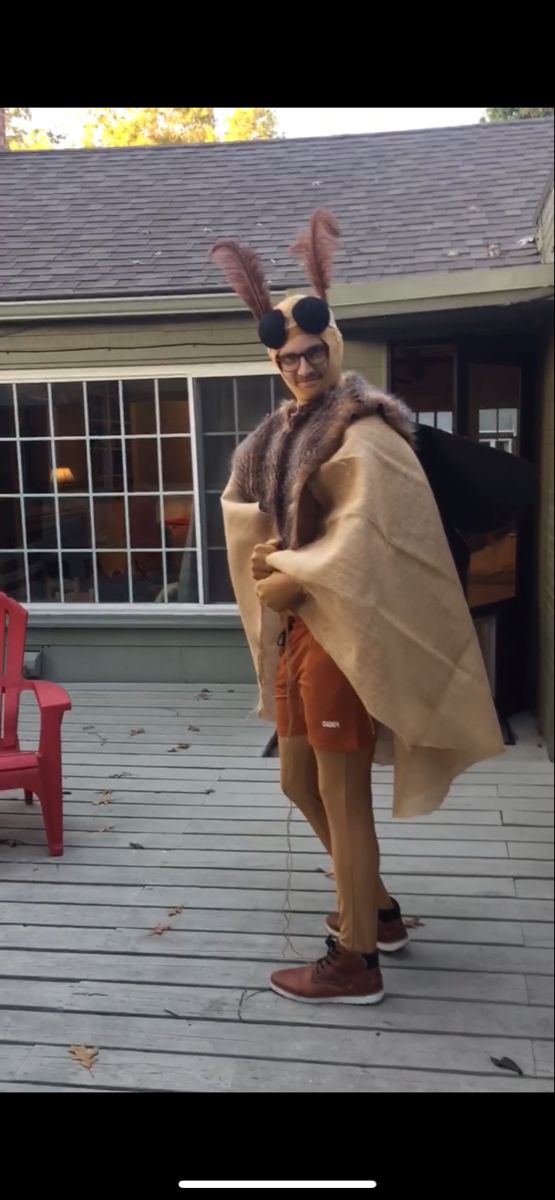 a man dressed up as a rabbit standing on a deck