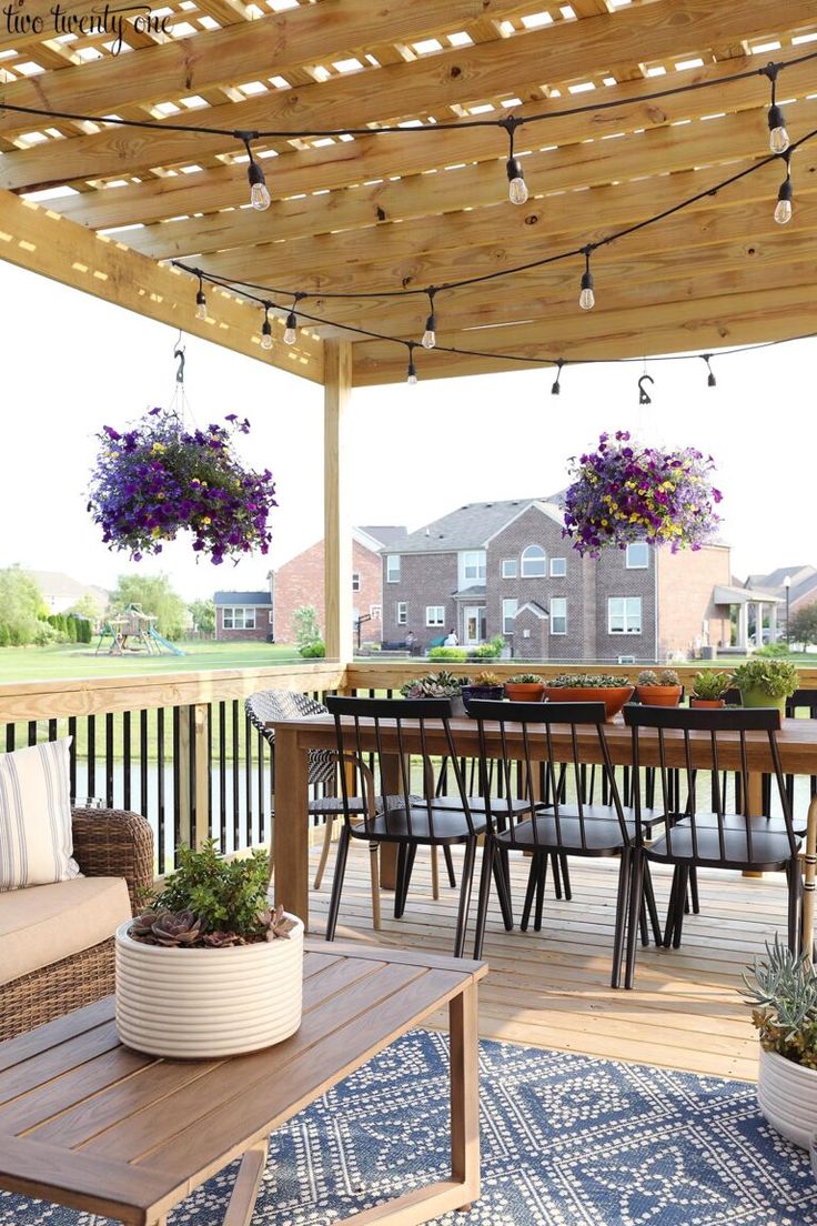 an outdoor deck with seating and potted plants