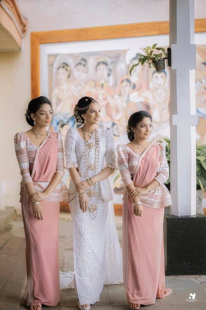 three women standing next to each other in dresses