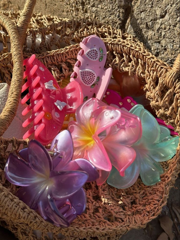 a basket filled with lots of colorful plastic flowers