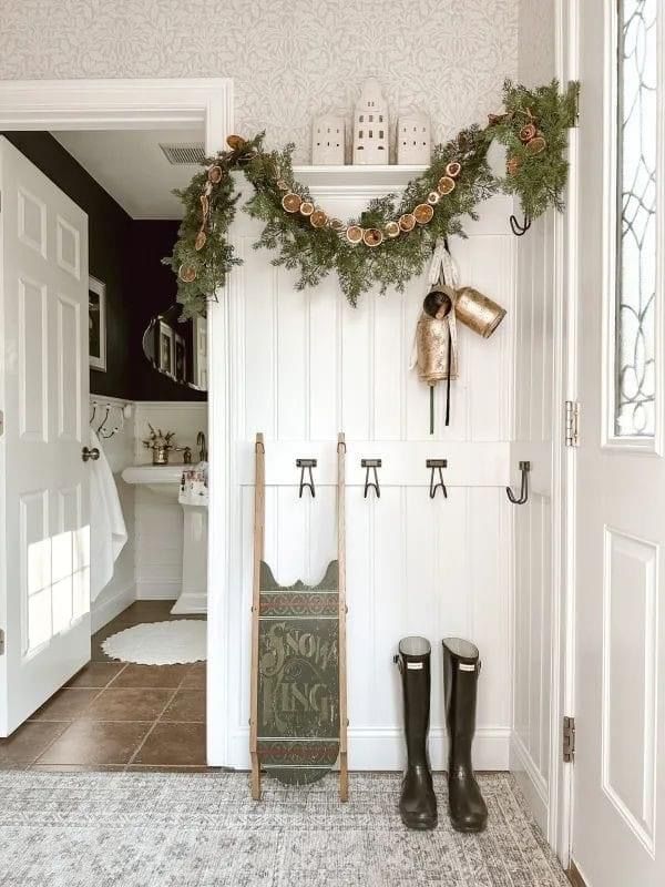 the entry way is decorated with christmas garland and boots