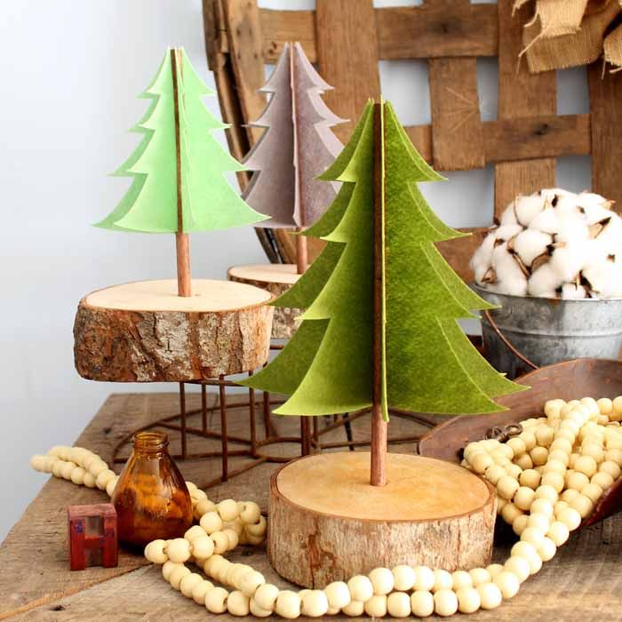 a wooden table topped with christmas trees and nuts