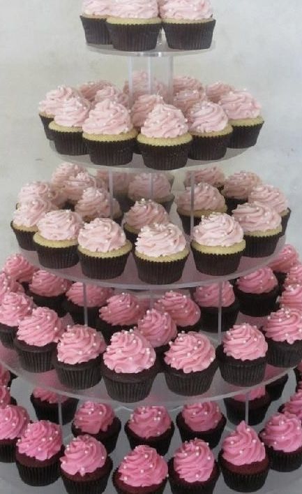 cupcakes are arranged in the shape of a tower