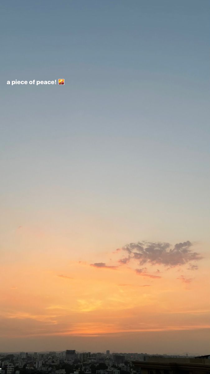 the sun is setting over a city with tall buildings in the foreground and an airplane flying overhead