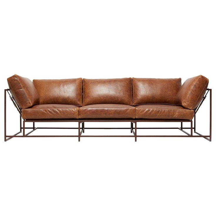 a brown leather couch with metal frame and backrests on an isolated white background