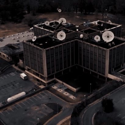 an aerial view of two large buildings with air conditioners on top