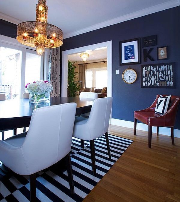 a dining room table with white chairs and a chandelier hanging from the ceiling