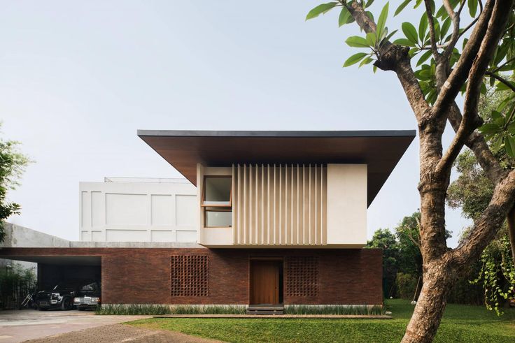 the house is surrounded by trees and grass